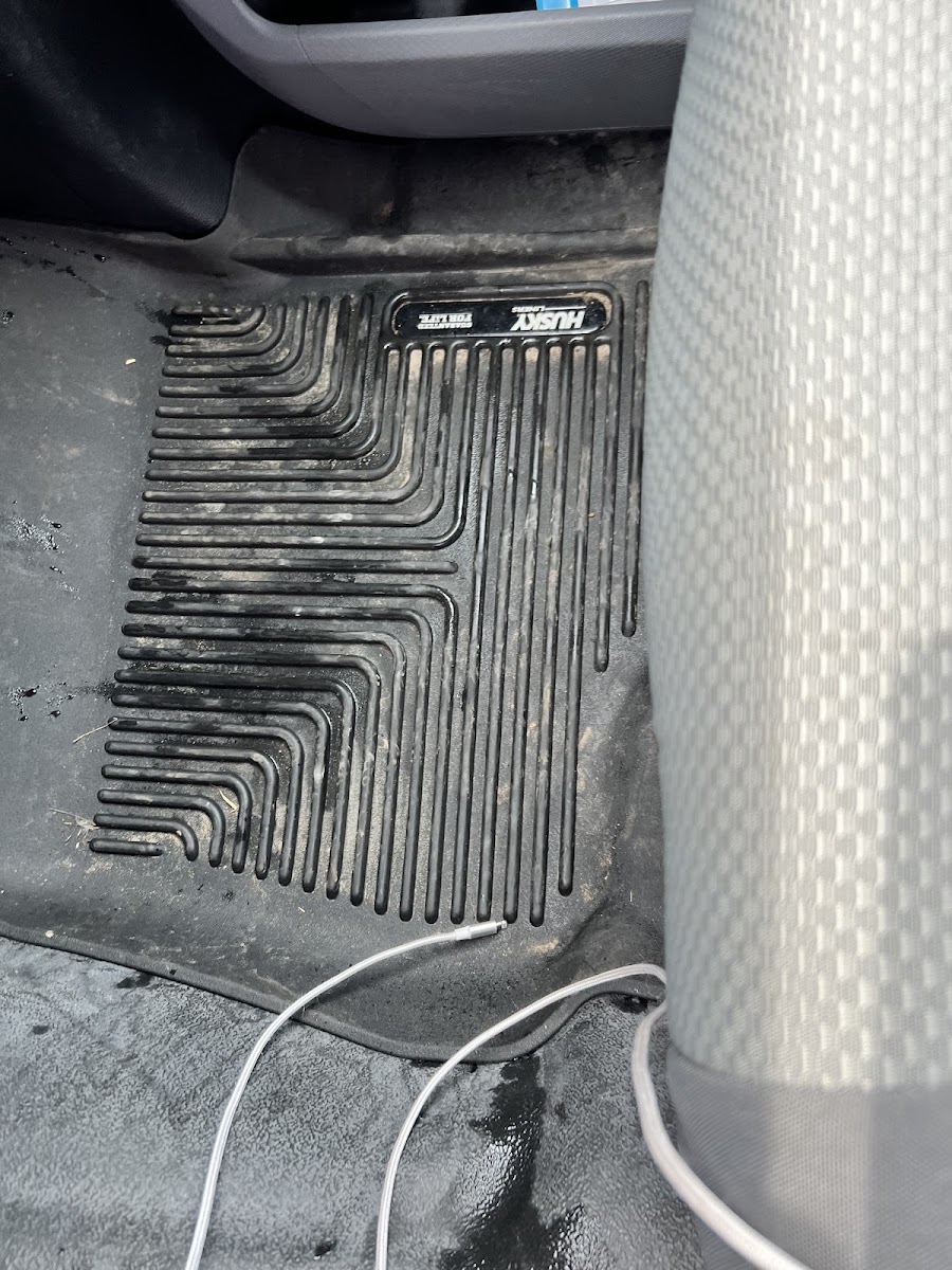 Dirty rubber floor mat before an interior detail — the kind of winter grime we clean every day.