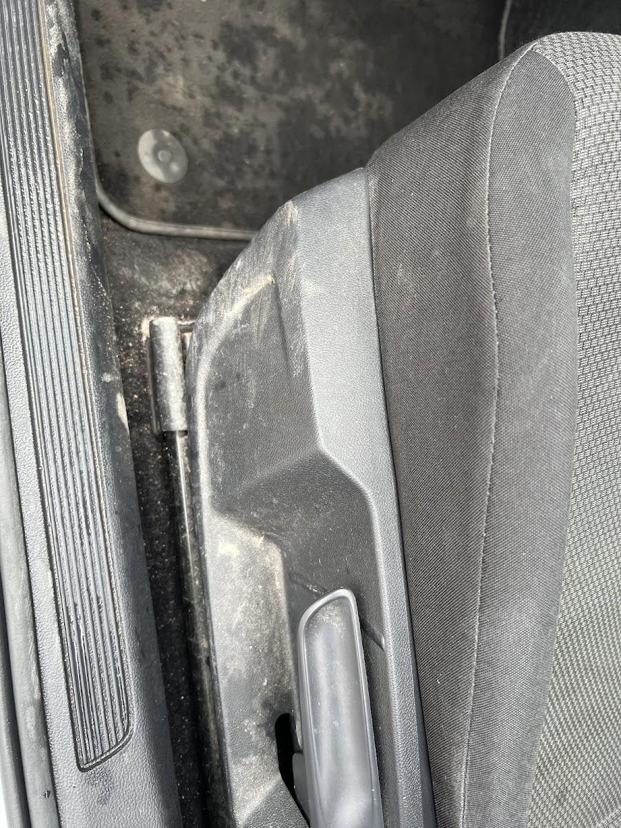 Muddy seat base and footwell before deep cleaning.